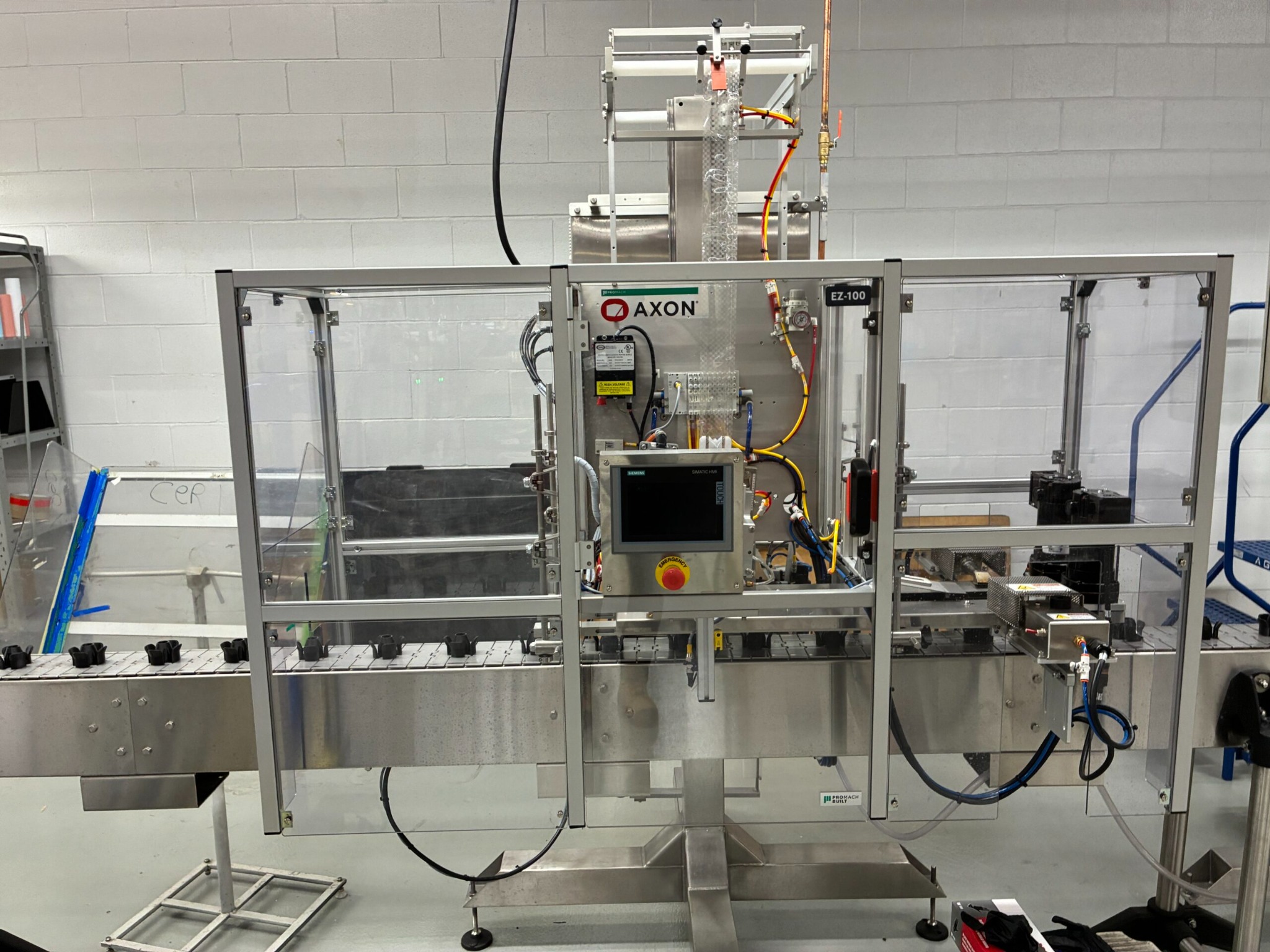 Close view of the AXON EZ-100 sleeve labelling equipment